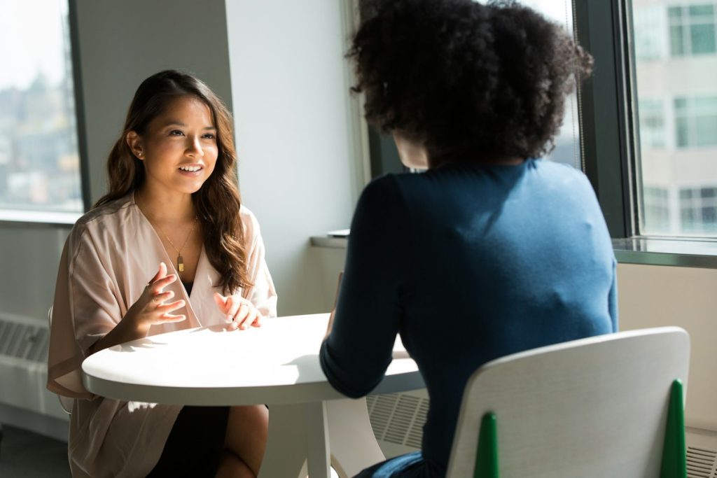 An instructional coach and a teacher reviewing lesson notes in a post-observation meeting