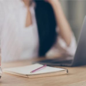 Woman at her desk working on her laptop