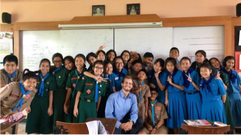 TEFL teacher in Thailand surrounded by young learners