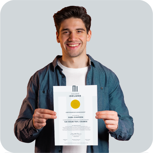 Man holding TEFL certificate