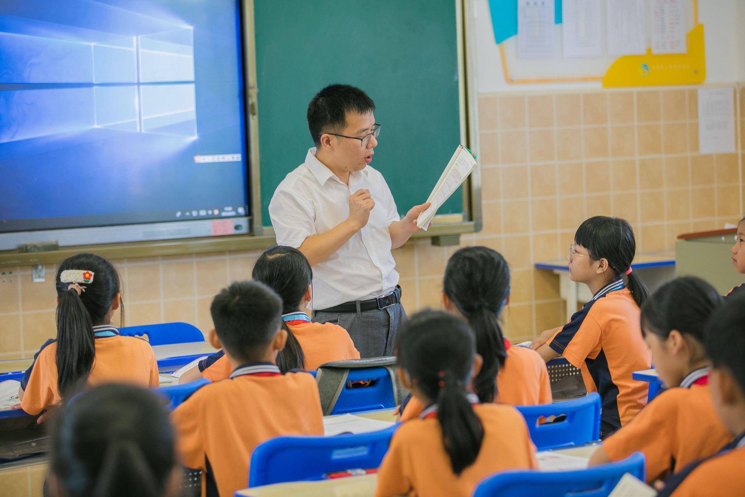 Teacher using gestures and total physical response commands with young learners in an ESL classroom