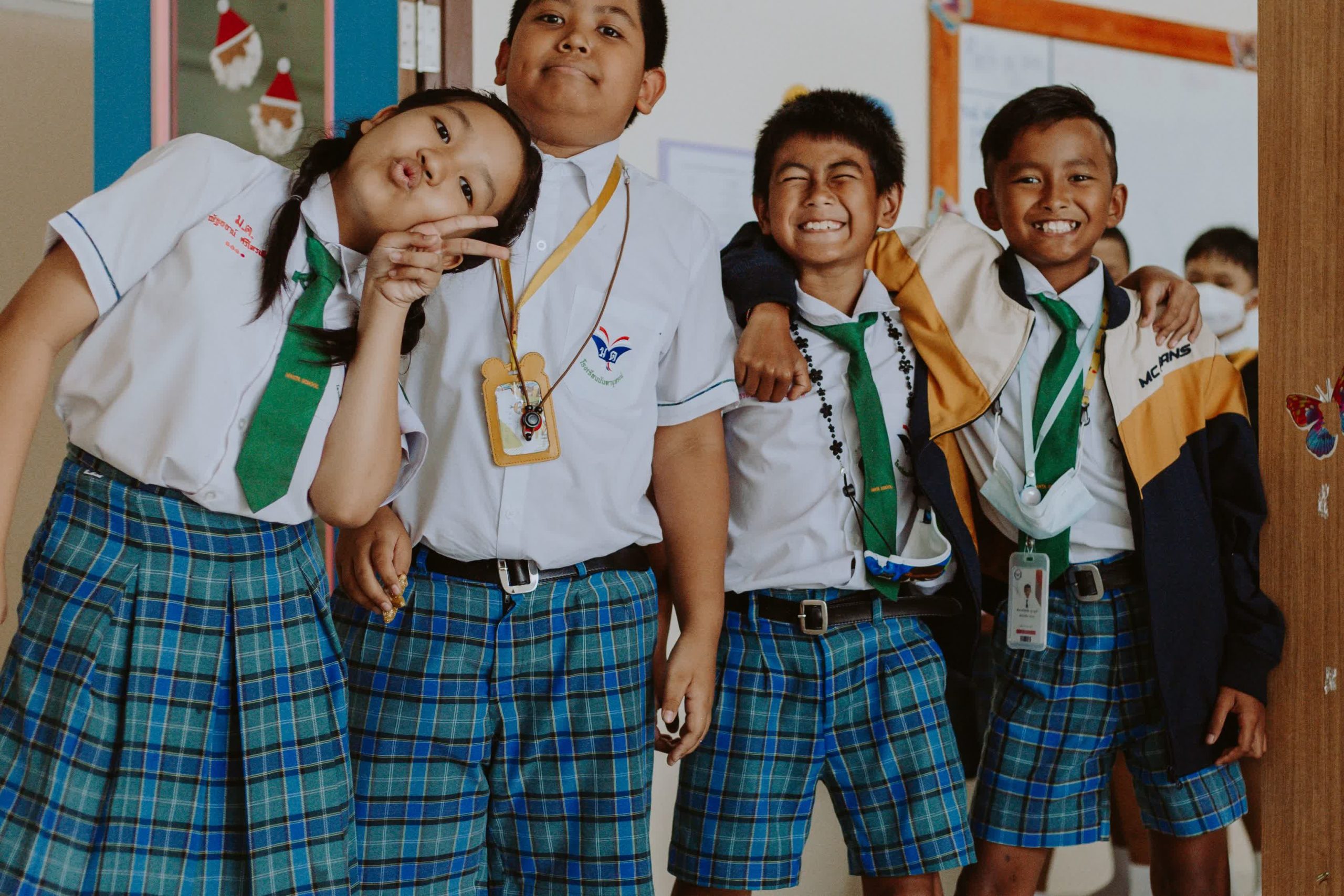 Group of teenage students standing together in a classroom doorway, suited to teenage total physical response activities