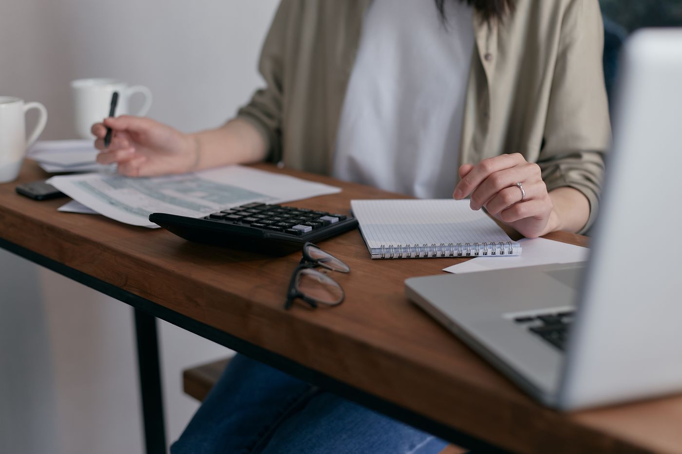 Trainee researching an Ofqual regulated Level 5 accredited TEFL certification on a laptop