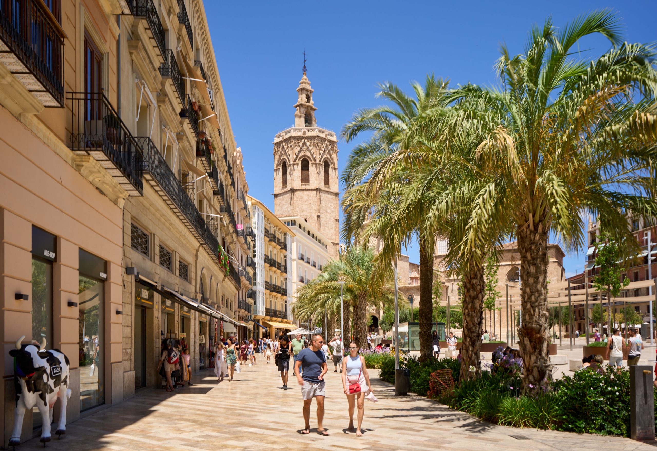 Street in central Valencia with the cathedral bell tower, a mid-cost Spanish city where teachers weigh rent against the cost of living