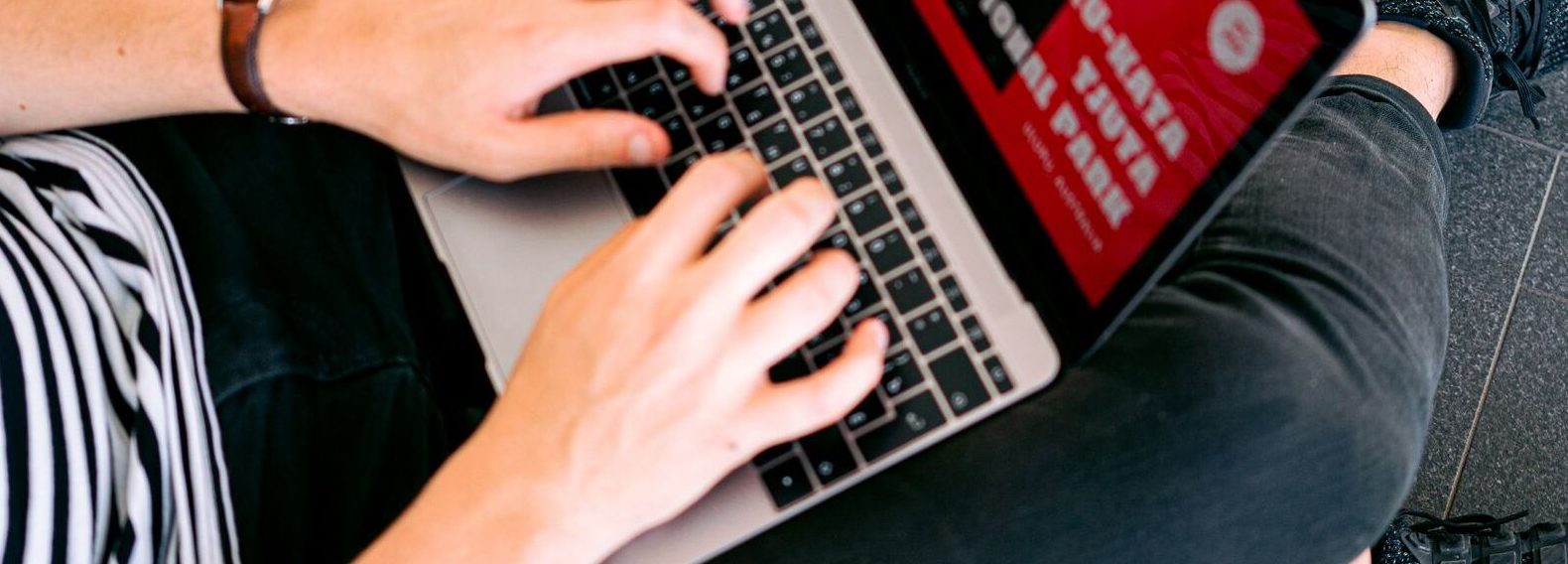 Teacher at a laptop preparing to teach English online to Chinese adult students