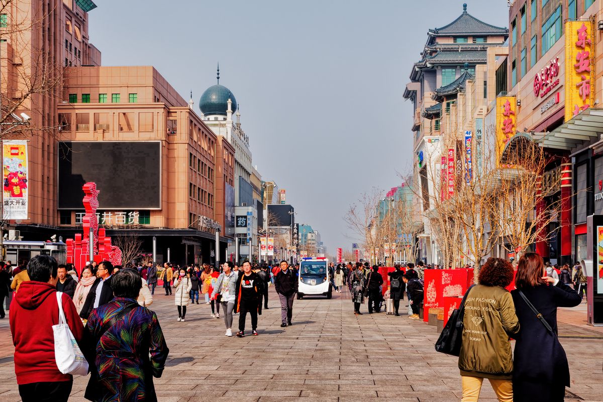People walking on a Beijing street, reflecting the adult learners who now study English online in China