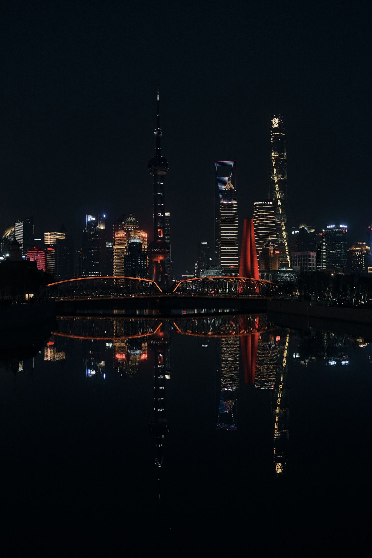 Shanghai city skyline lit up at night, home to many online English students across China