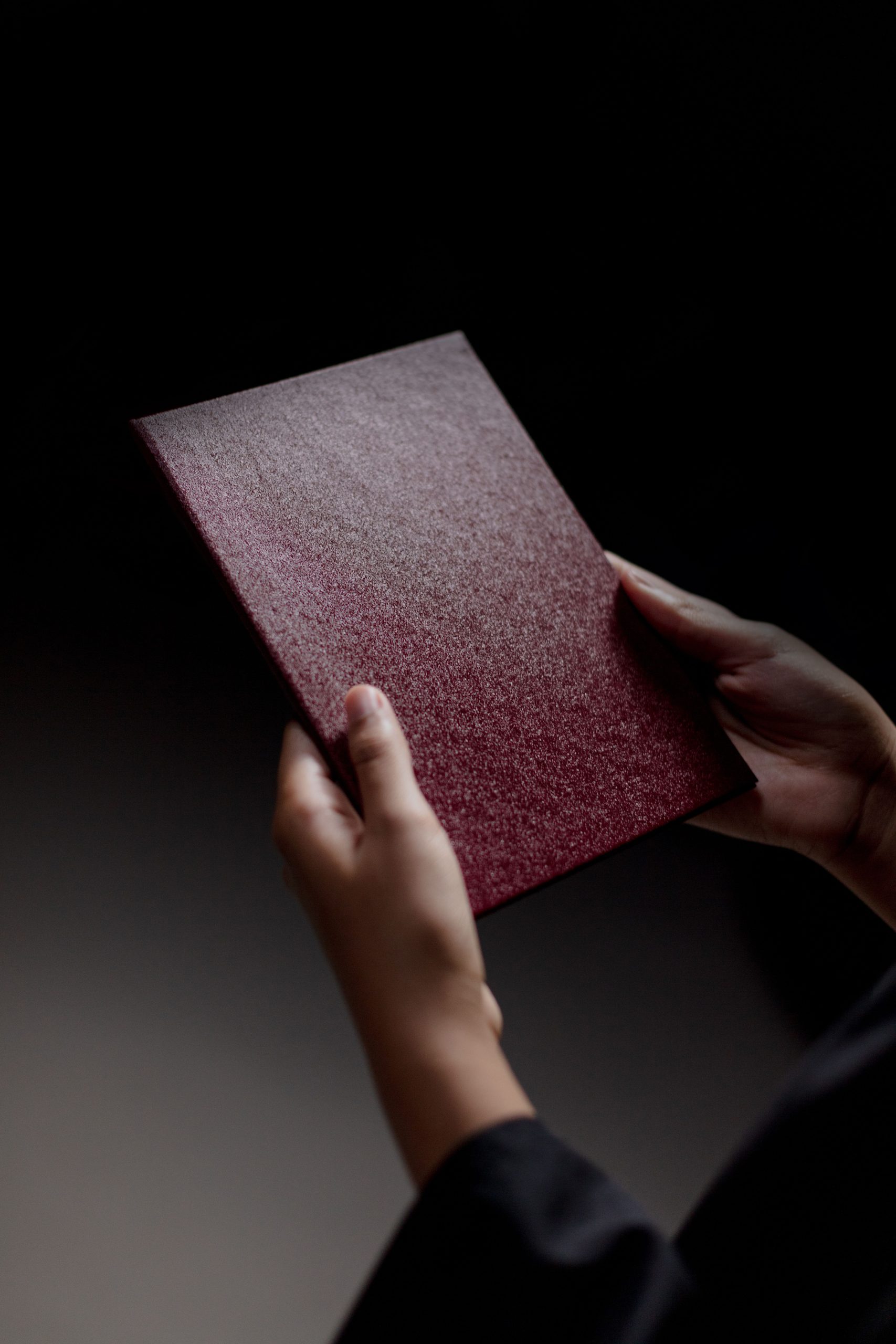 Hands holding a diploma, representing the regulated Level 5 TEFL qualification a higher course fee pays for