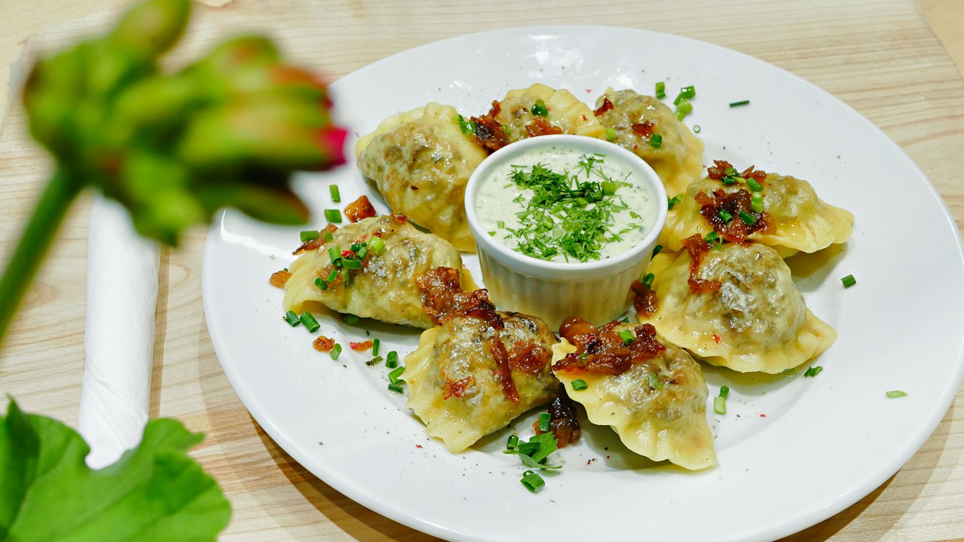 Plate of Polish pierogi, a cheap and filling meal that keeps food costs low for teachers in Poland