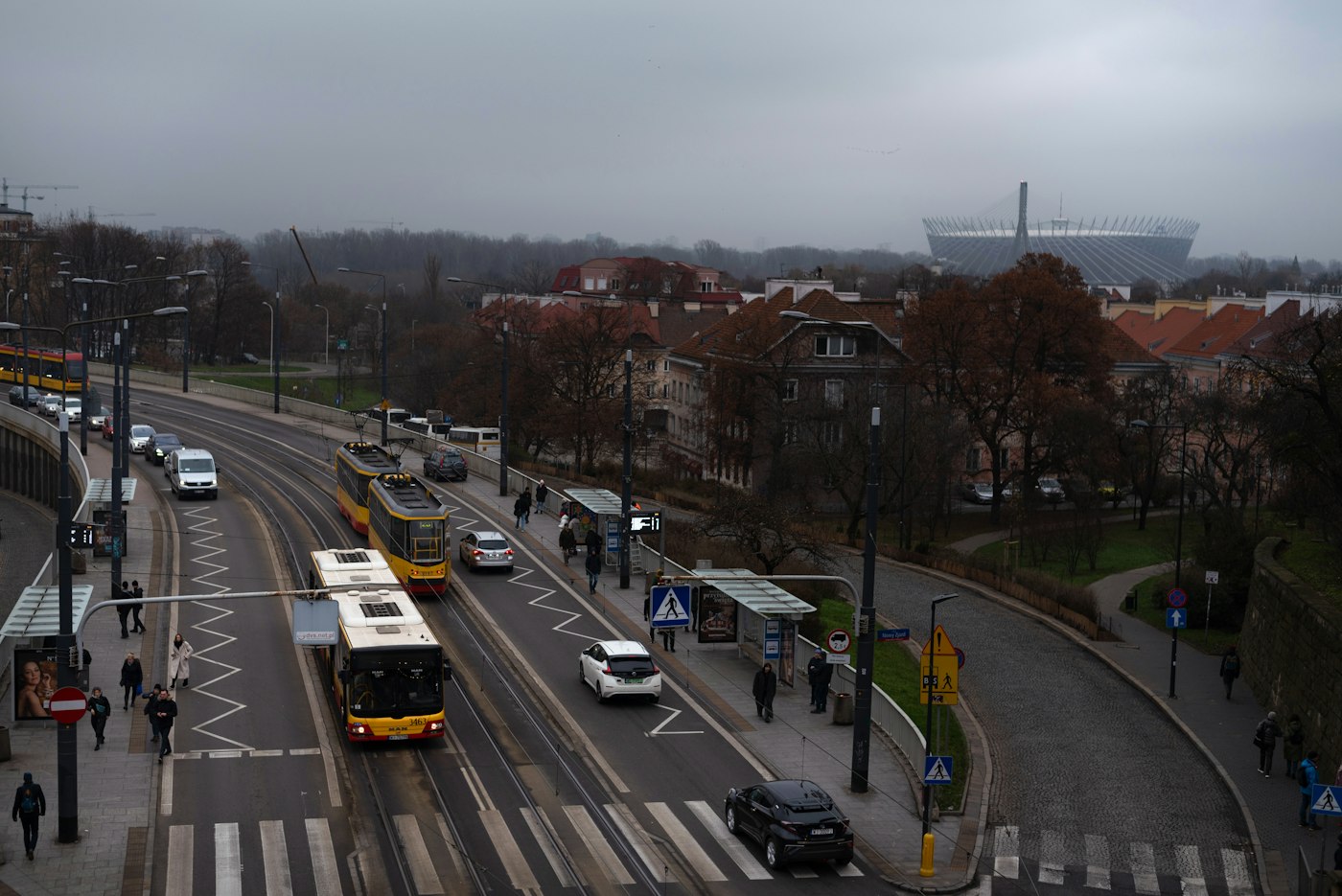 Tram and traffic on a Warsaw street, the cheapest way for English teachers to get around Polish cities