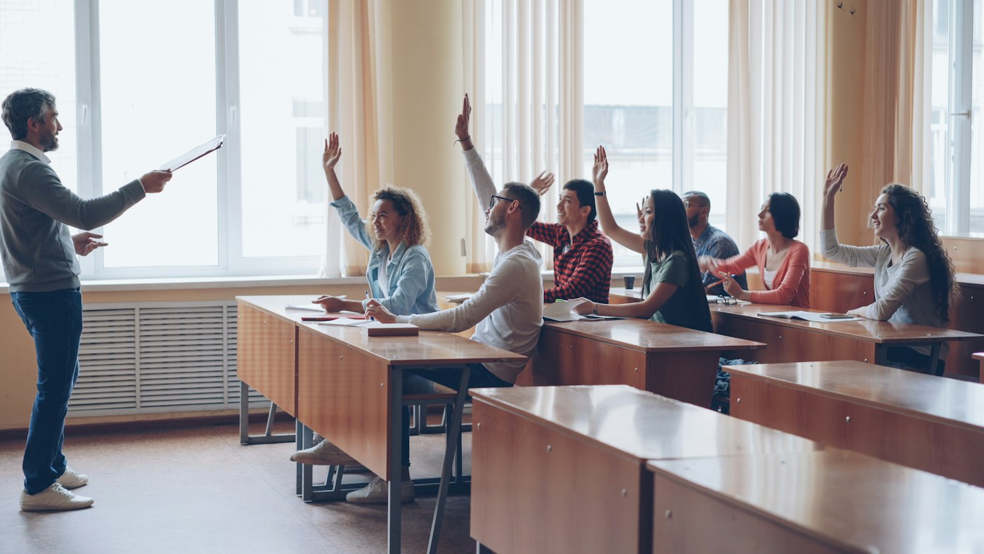 QTLS and a TEFL qualification compared as a teacher plans an ESOL lesson for adult learners