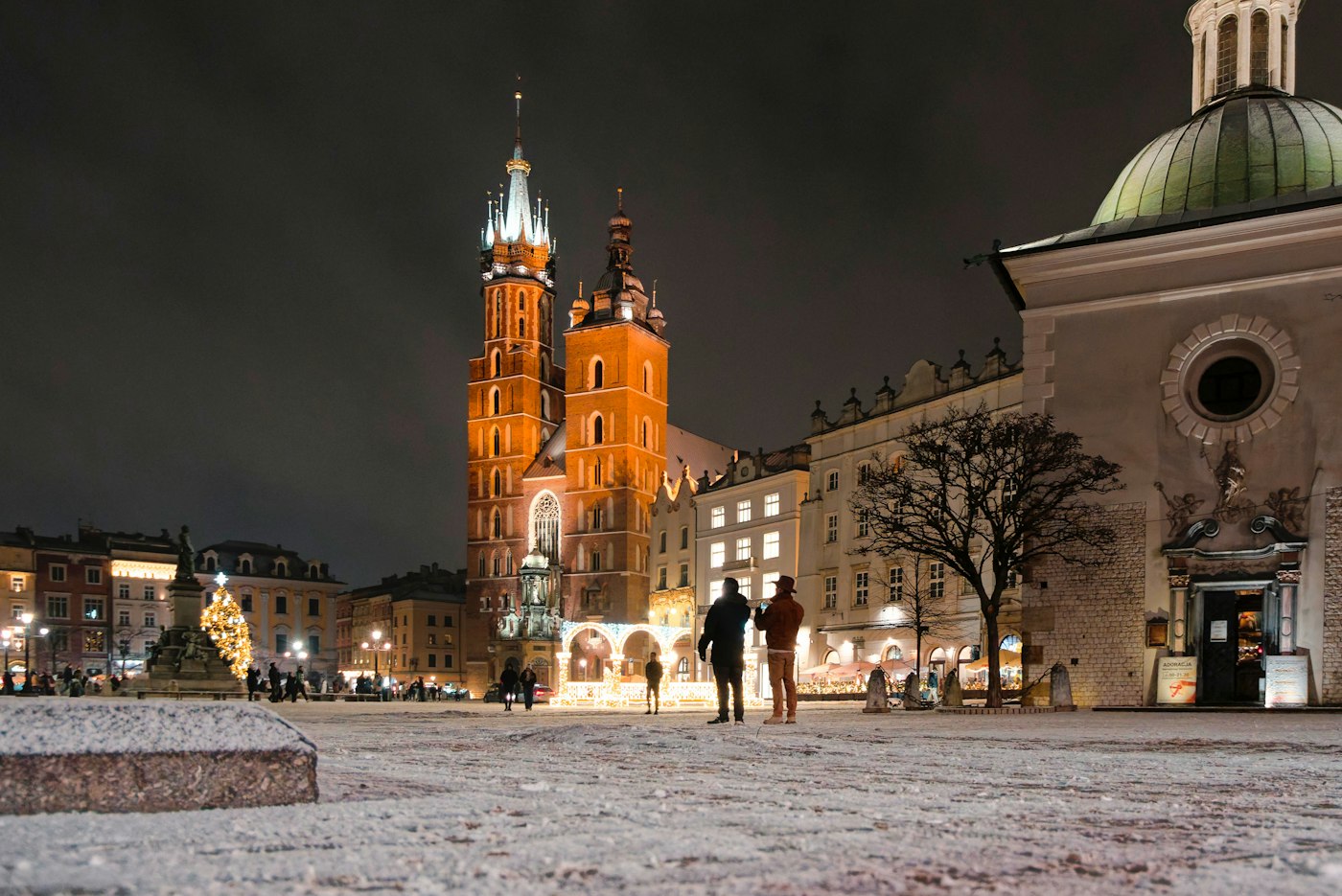 Krakow old town square lit up at night, a popular base for UK and US English teachers in Poland