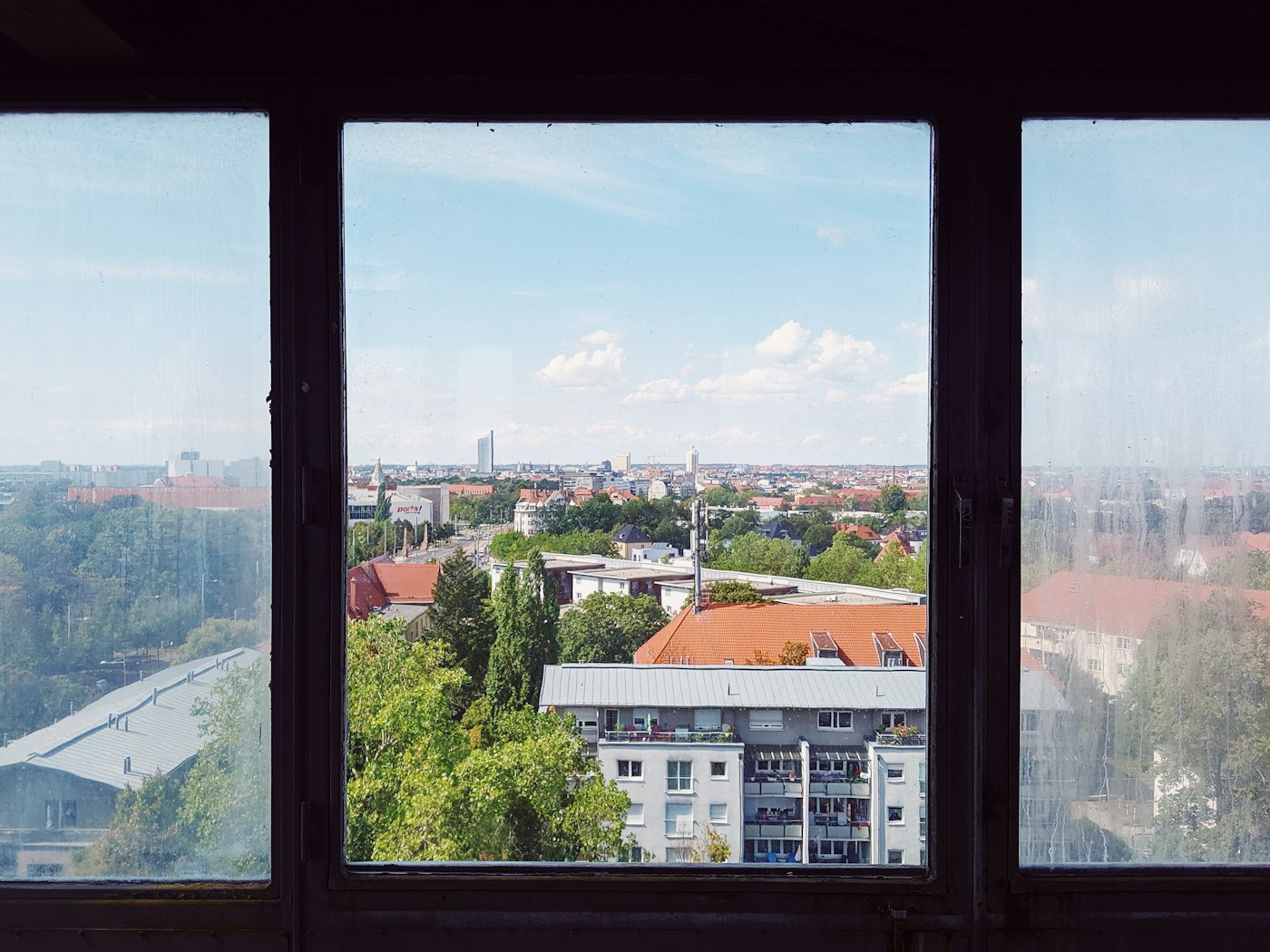 Tower and rooftops in Leipzig, a city where English teachers in Germany pay far less rent than in Munich or Berlin
