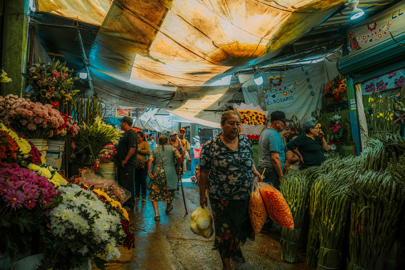 Busy flower market in Mexico, where English teachers keep food and household costs low