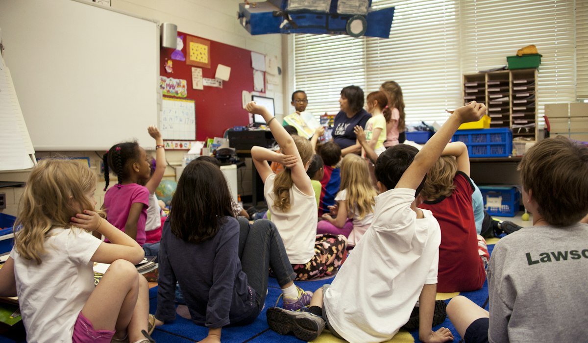 ELL students sitting together during a shared reading lesson in an elementary classroom