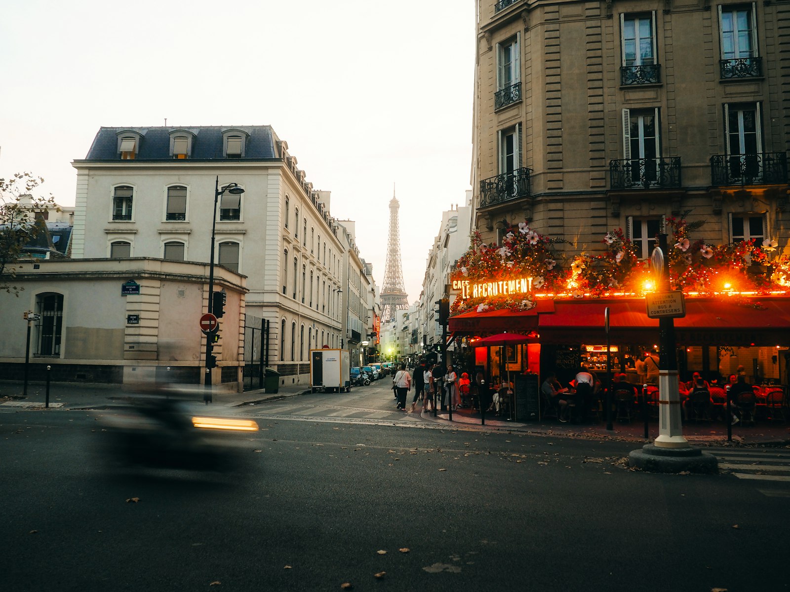 The Eiffel Tower seen from a Paris street cafe in the evening