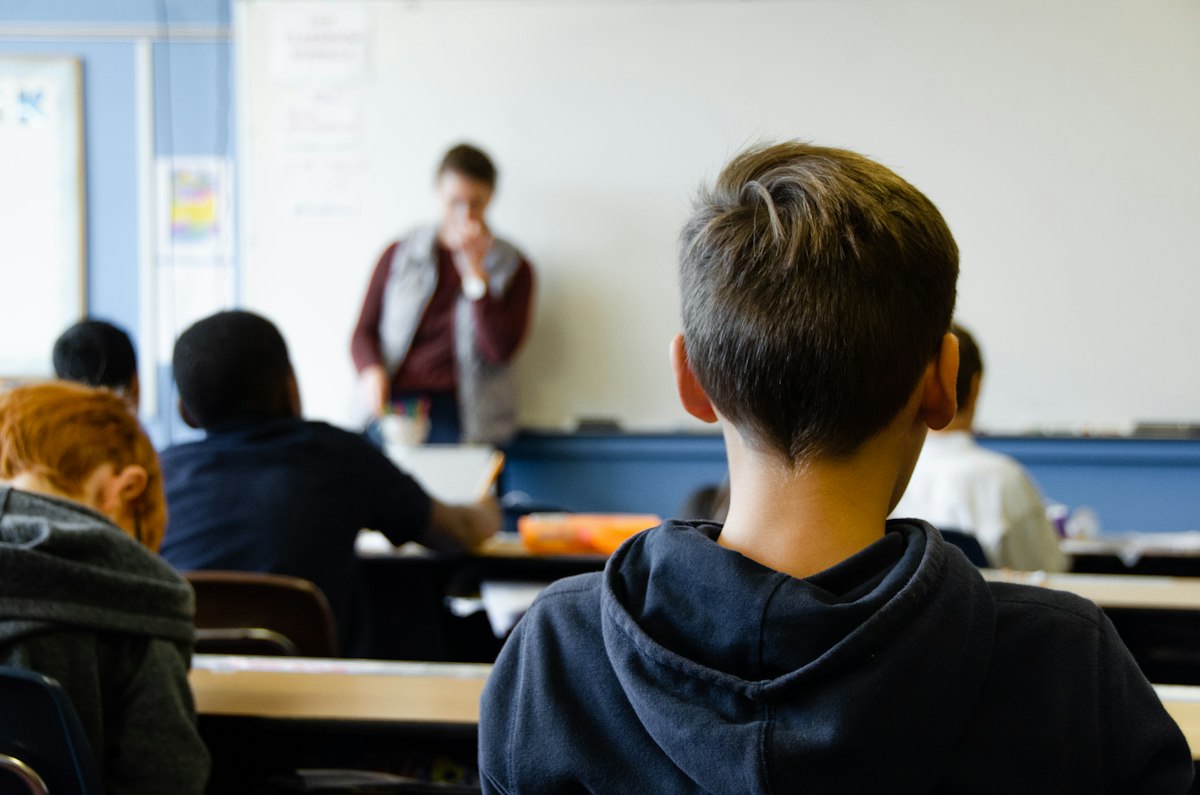 Students working in a small group with classroom support under a licensed teacher's supervision