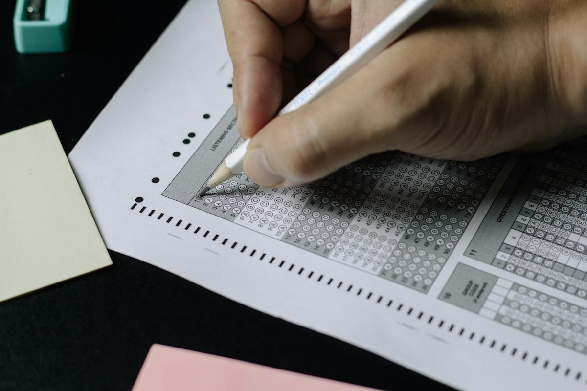 Candidate preparing for a Praxis Core or Praxis Subject test by writing practice answers
