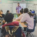 SLIFE students with limited or interrupted formal education in a US classroom with teacher