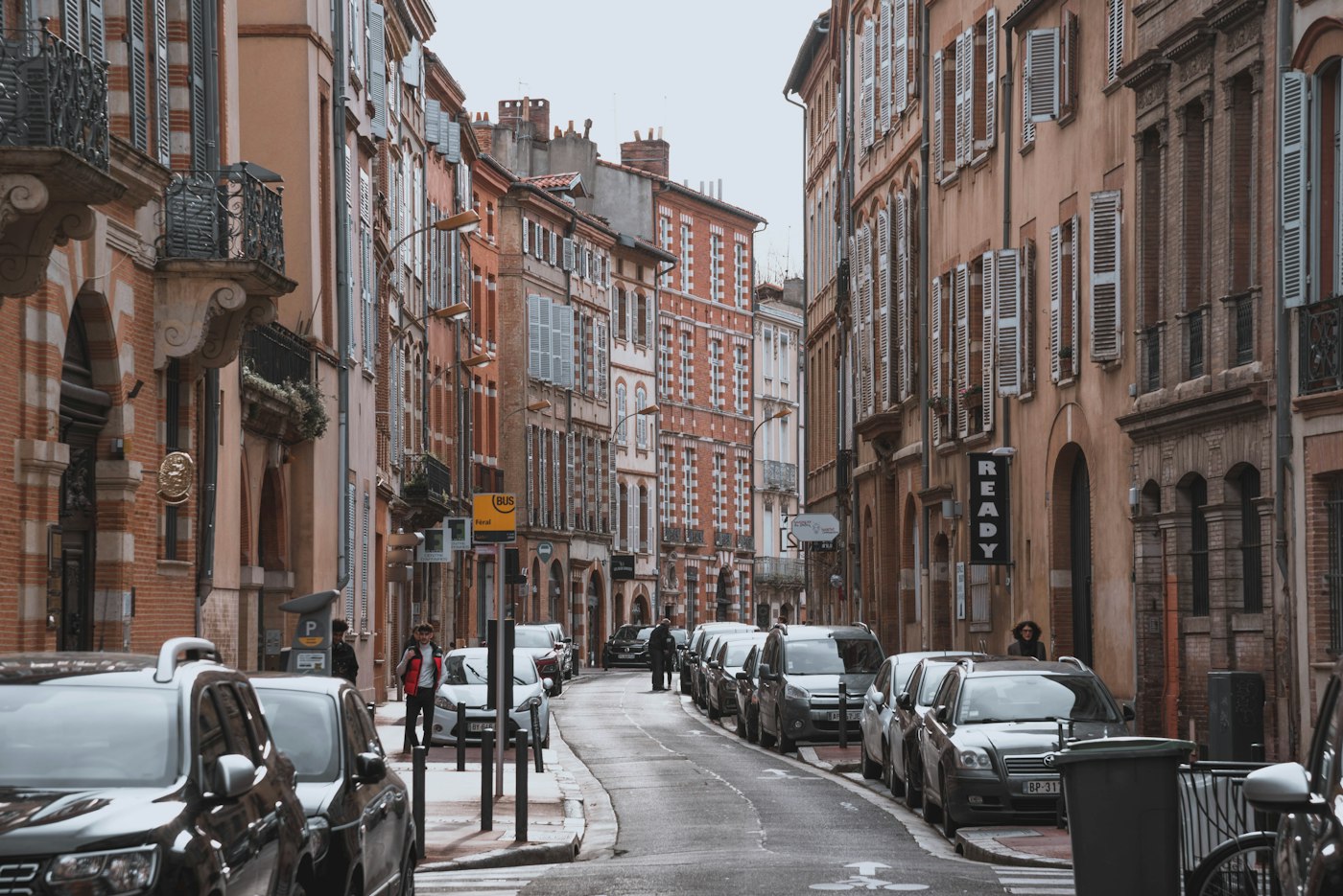 Narrow street of pink brick buildings in Toulouse, a popular regional placement for TAPIF assistants in France